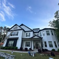 Two-story home with freshly painted white and black exterior