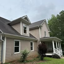 Tan sided home with white trim and covered porch