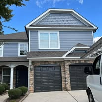 Townhome exterior with blue-gray siding and stone accents