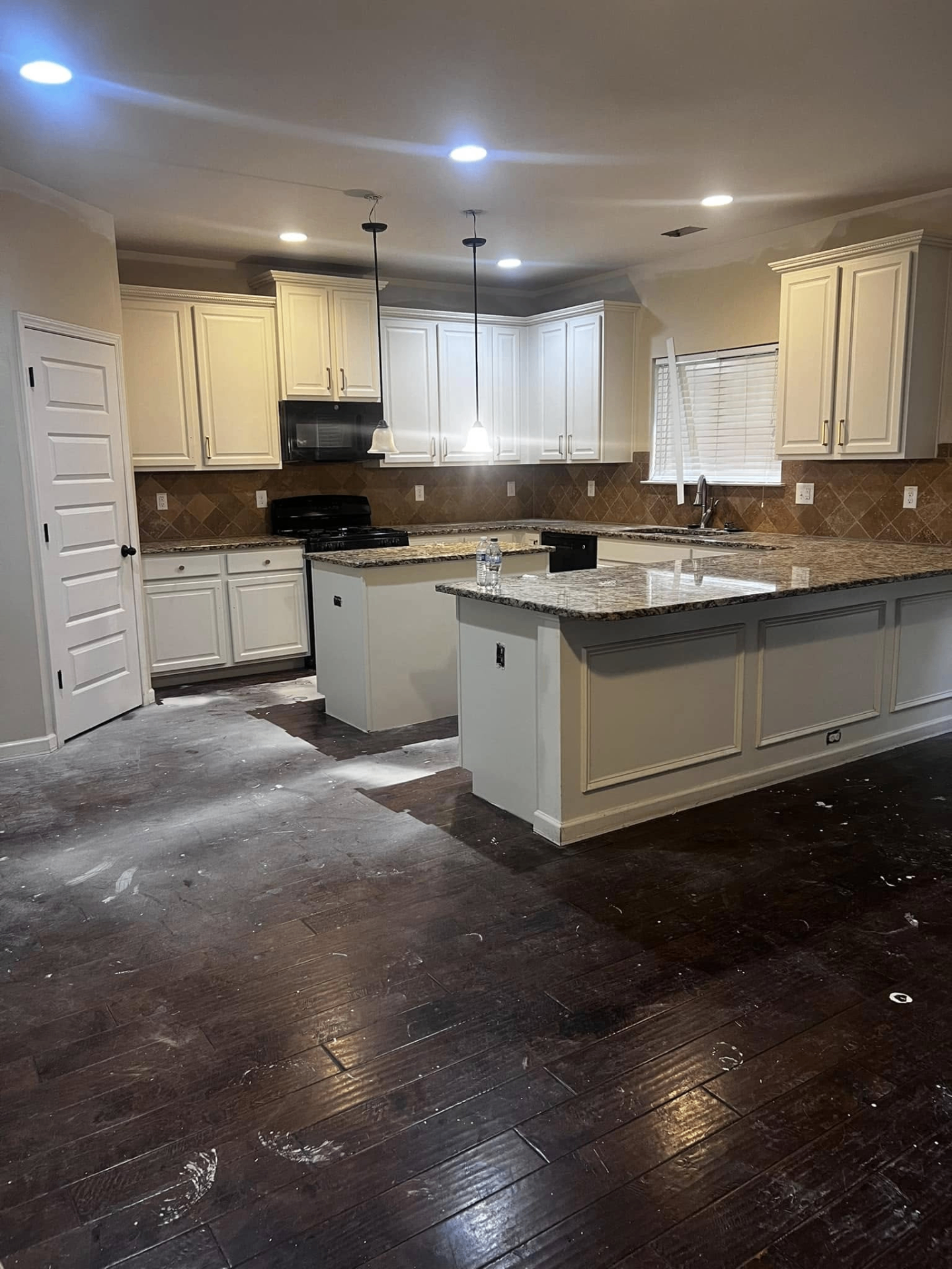 Kitchen with painted cabinets and granite countertops