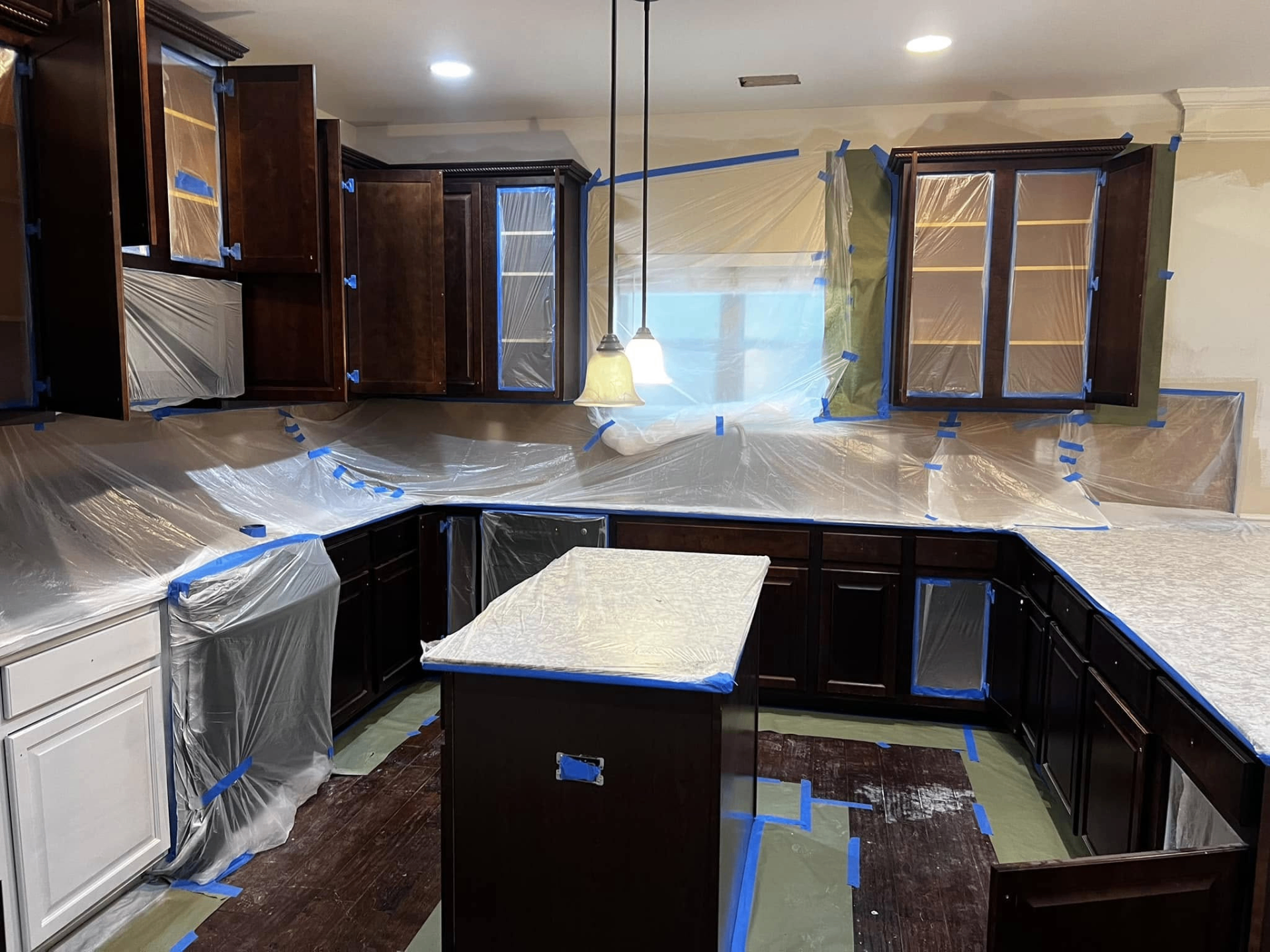 Kitchen cabinets prepped and masked for refinishing